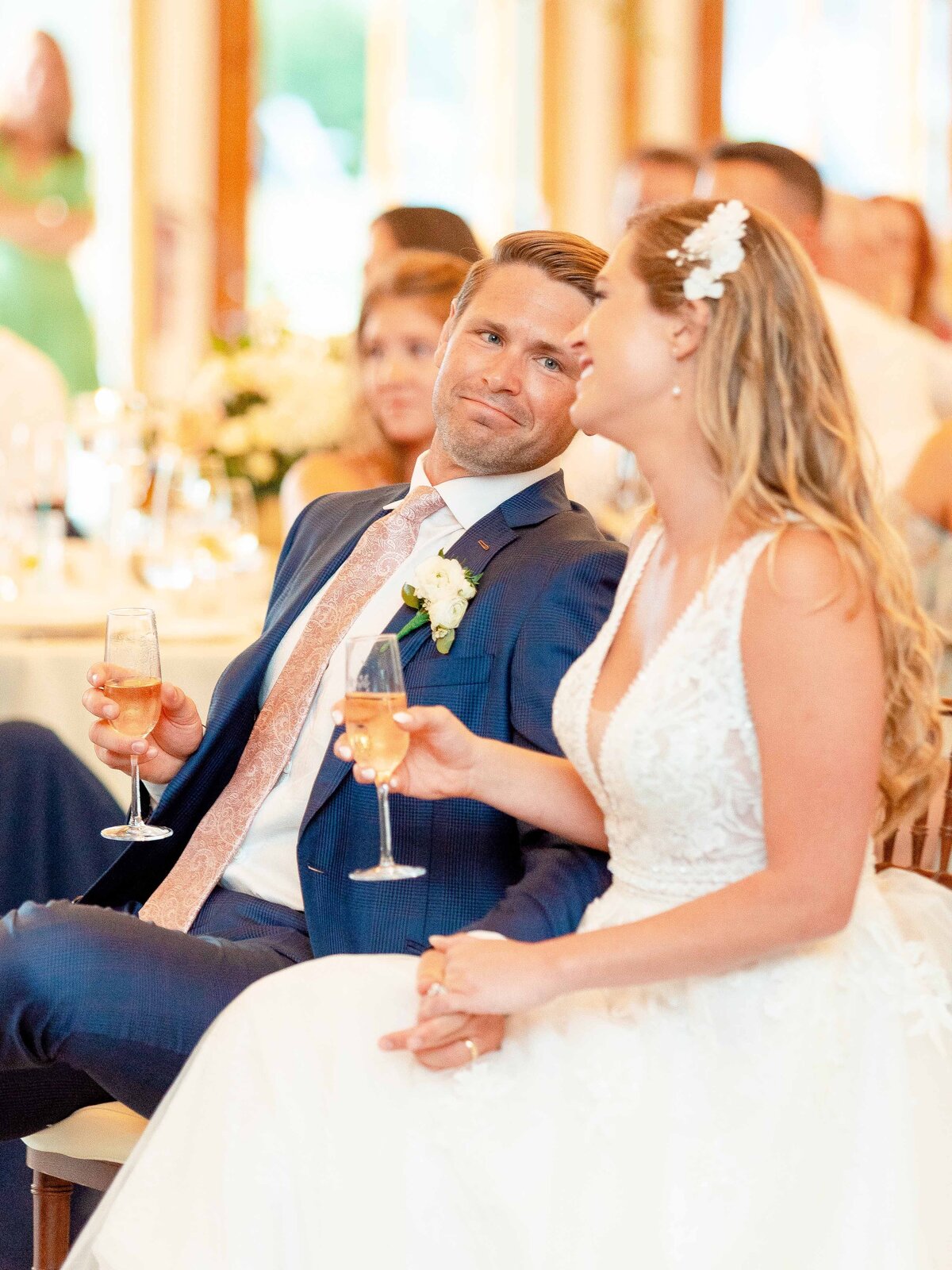 Groom looks at his wife during toasts at his wedding reception in Newport, RI.