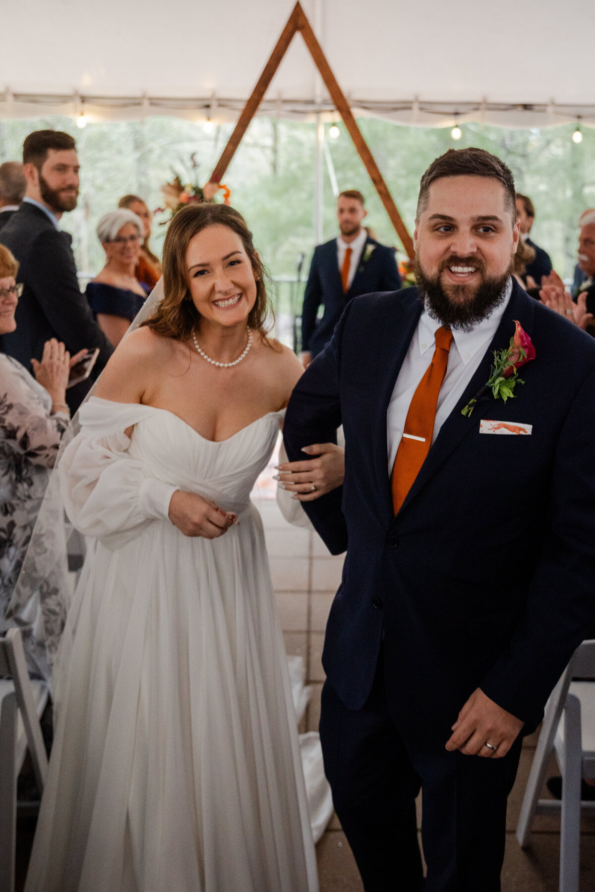 A photograph of a bride and groom walking down the aisle.