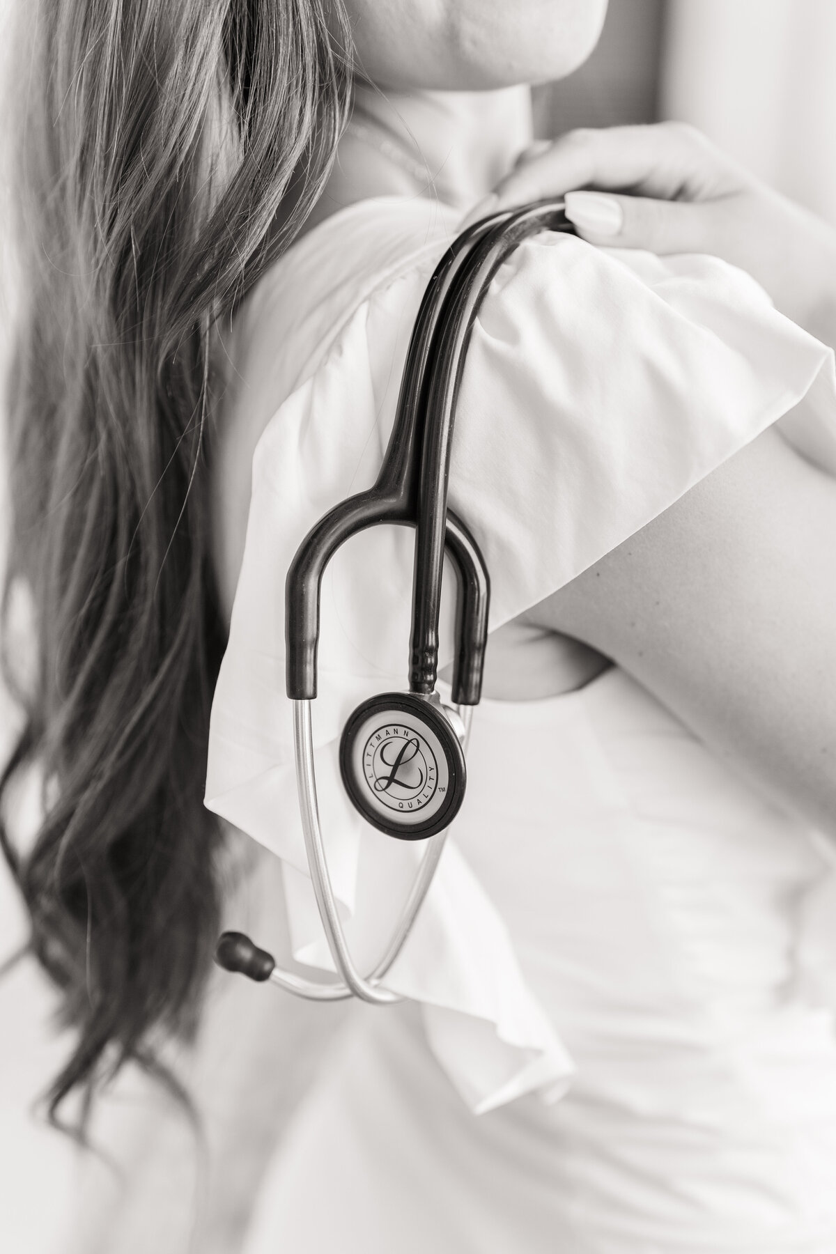 Texas A&M senior girl holding stethoscope over shoulder at Administration Building