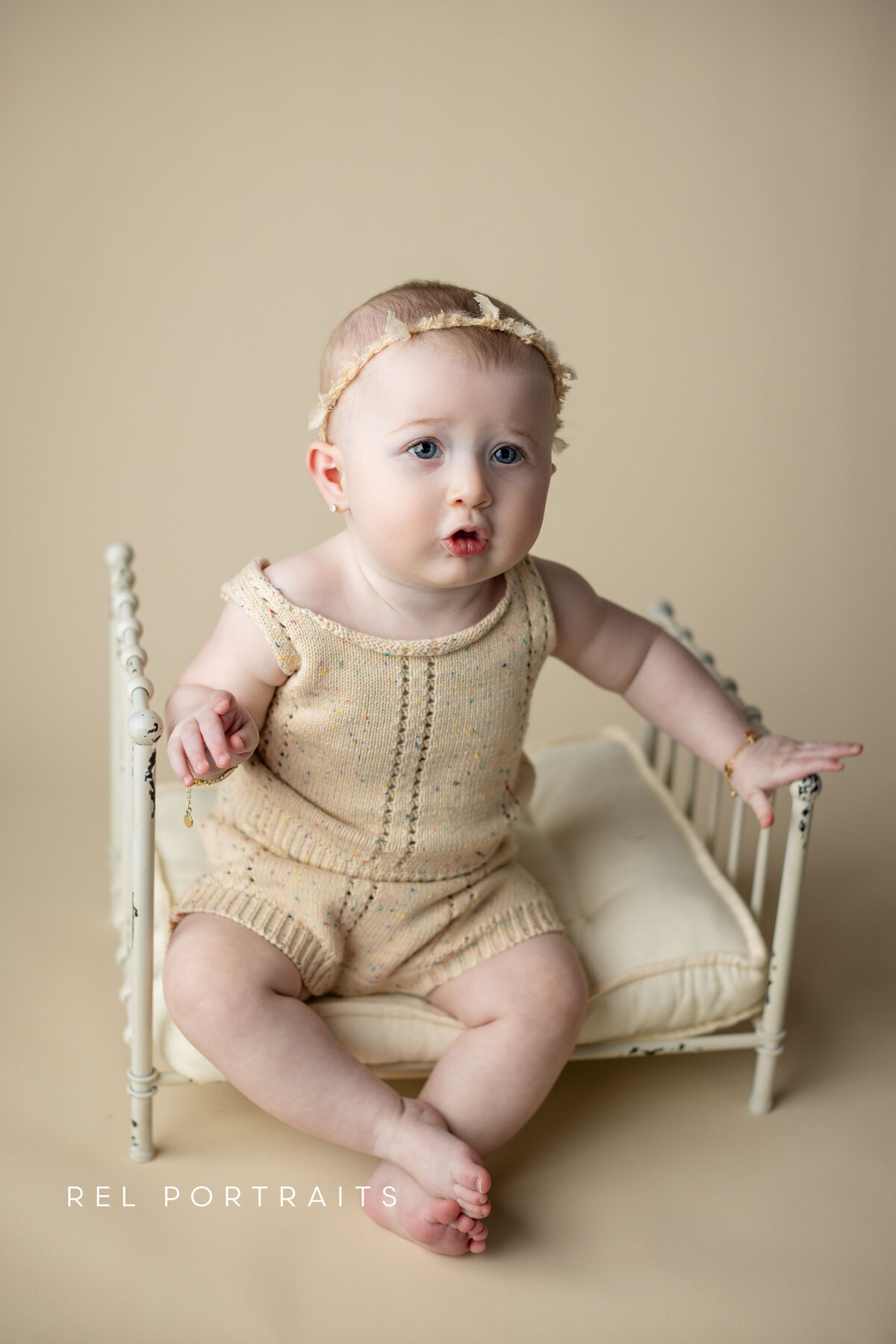 baby girl sitting on a bed in chicago