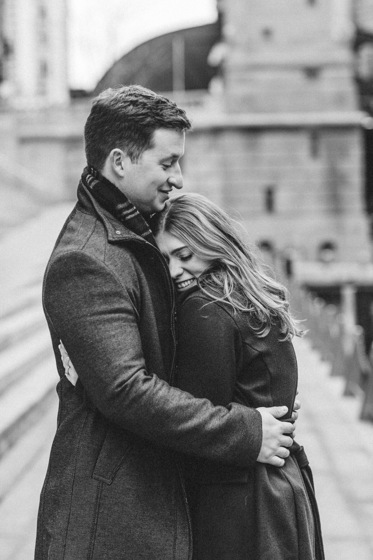 A newly engaged couple share an embrace on a chilly winter day in Chicago