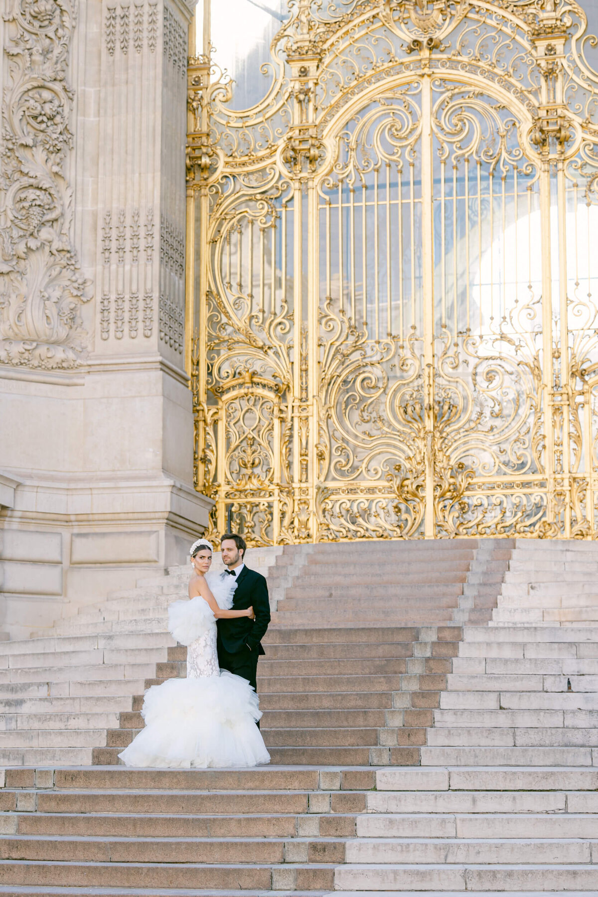 A wedding photo of a bride in her white dress in the streets of Paris in France.