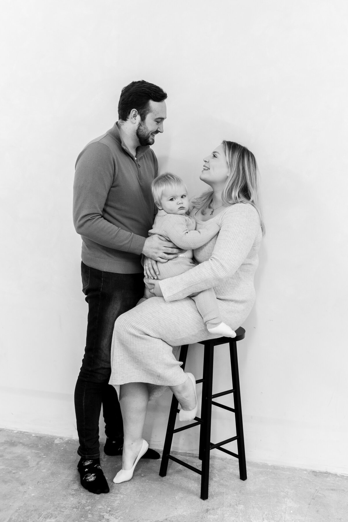 Happy family during studio session for family photoshoot and first birthday,