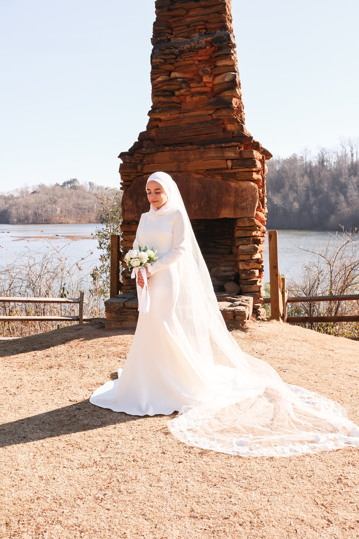 bride wearing hijab and a long lace veil at Morgan Falls Overlook Park by Atlanta elopement photographer Amanda Richardson Photography