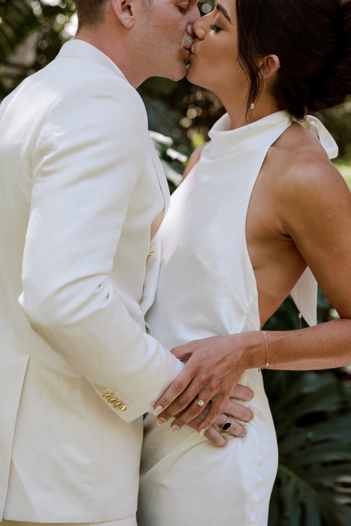 Bride and groom share their first kiss as newlyweds in Carmel, captured on film by Kate Winters Photography.