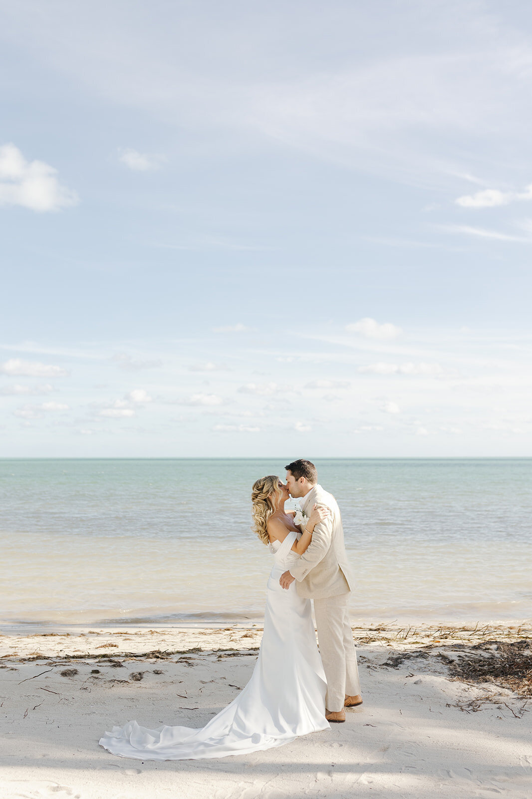 Monica and Austyn celebrate their love with a kiss against the serene backdrop of Islamorada’s beaches.