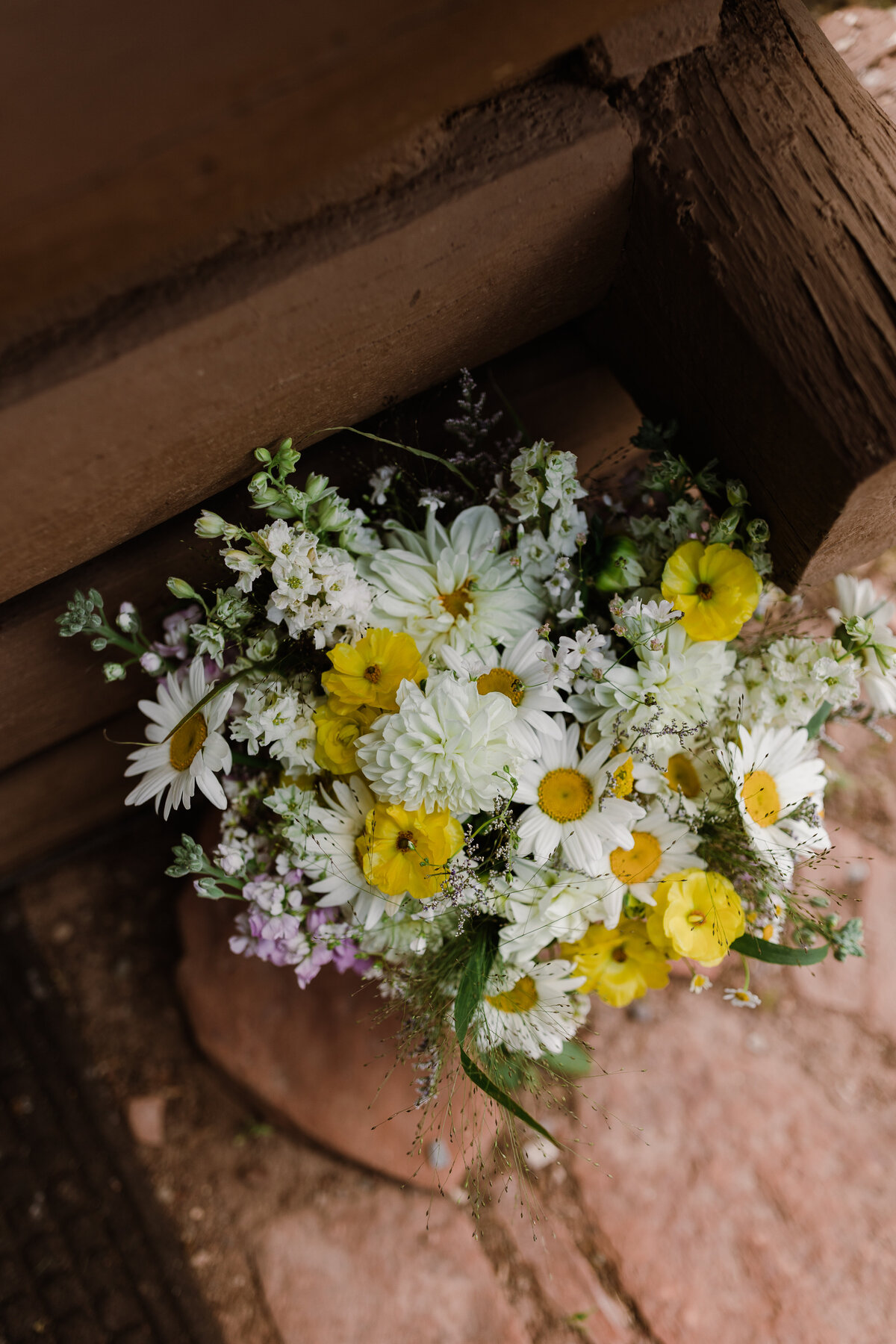 Florals including daisies and yellow flowers at Dallenbach Ranch Colorado Wedding