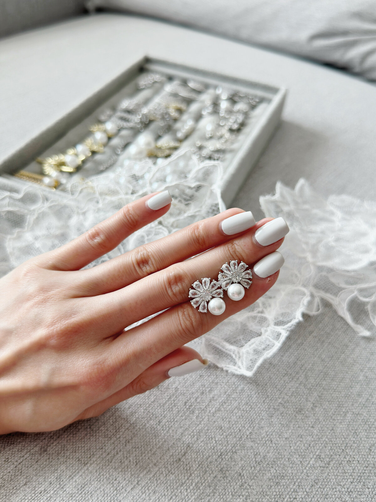 Delicate pearl drop earrings with fine crystal shimmer
