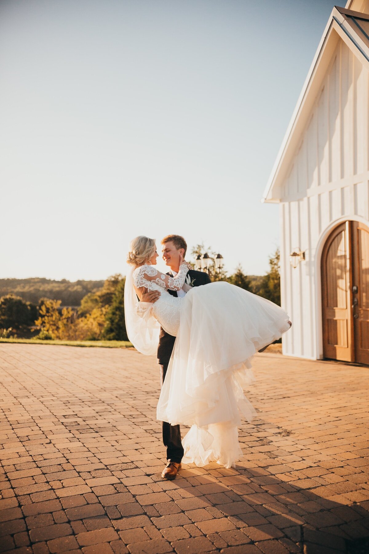 groom carrying his bride on their wedding day