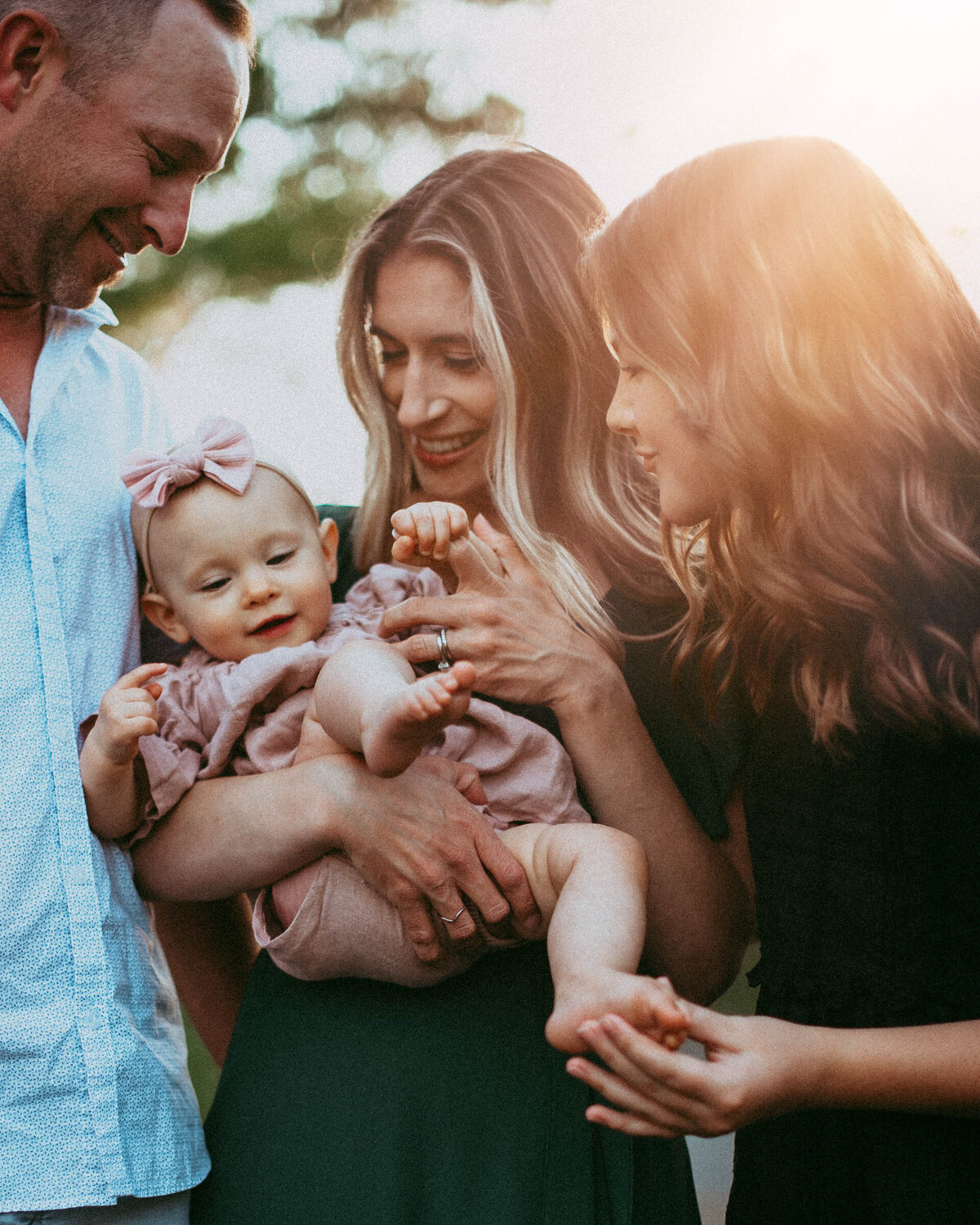 Family embraces baby on the Chesapeake Bay outdoor family photography