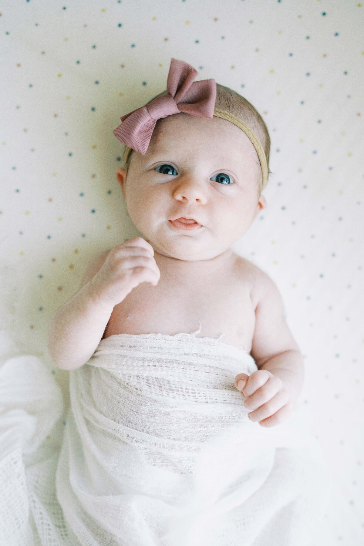 newborn baby looking at camera