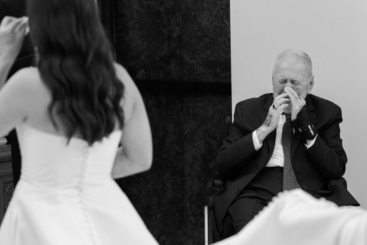 Emotional moment as bride’s grandfather wipes away tears during her wedding day at El Chorro in Scottsdale, captured by Arizona wedding photographers.