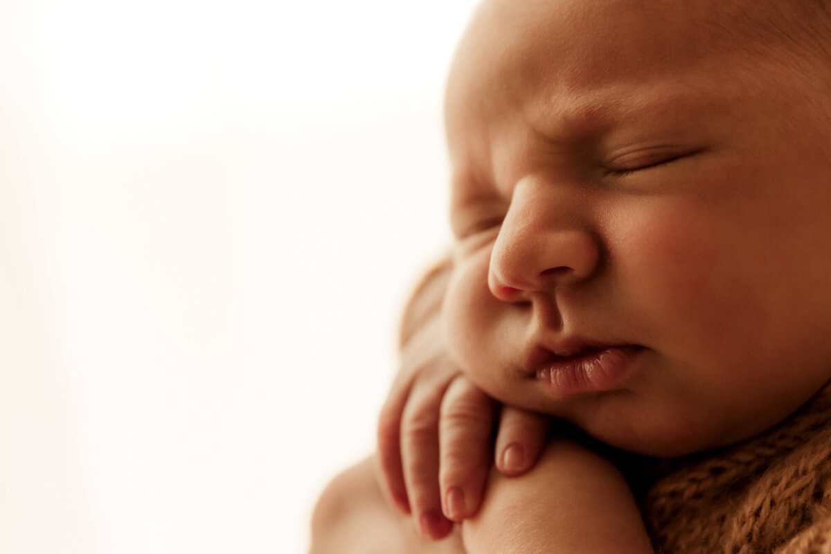 Macro photo of a newborn baby boy sleeping.