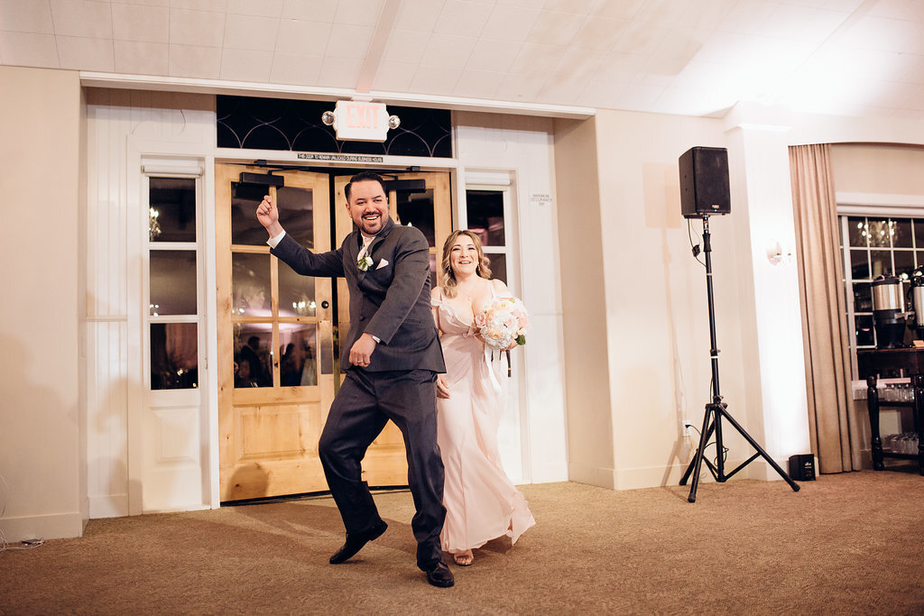 Wedding Photograph Of Groomsman Dancing And Bridesmaid Carrying a Bouquet Los Angeles