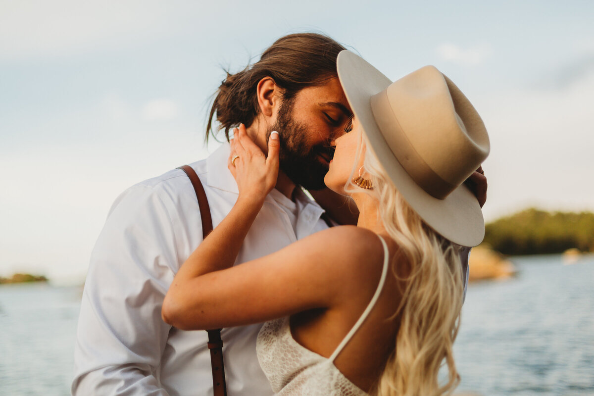 Newlyweds share a romantic kiss surrounded by the natural beauty of Redfeather Lakes, Colorado, after their intimate elopement.