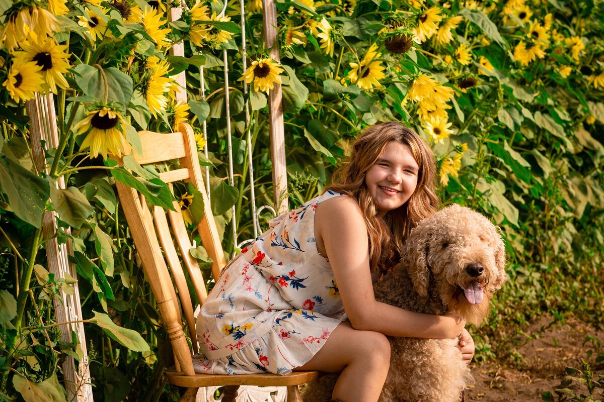 girl sitting with her dog