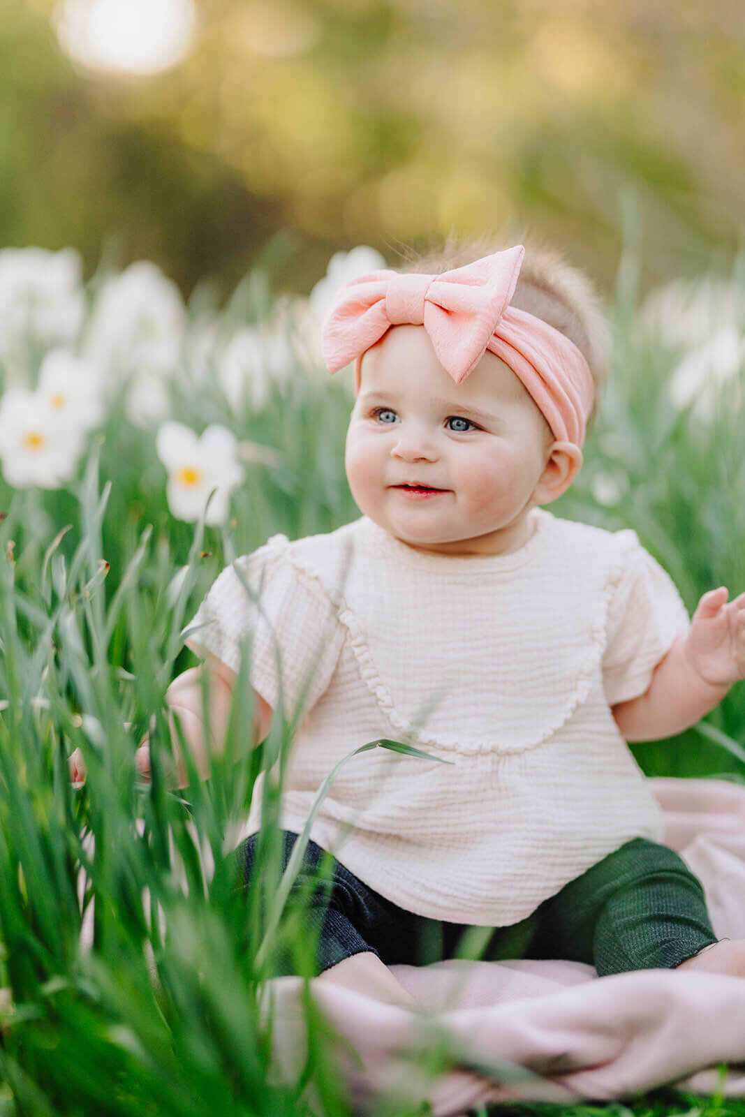 Baby sitting amongst flowers at family photo session in Finger Lakes, NY