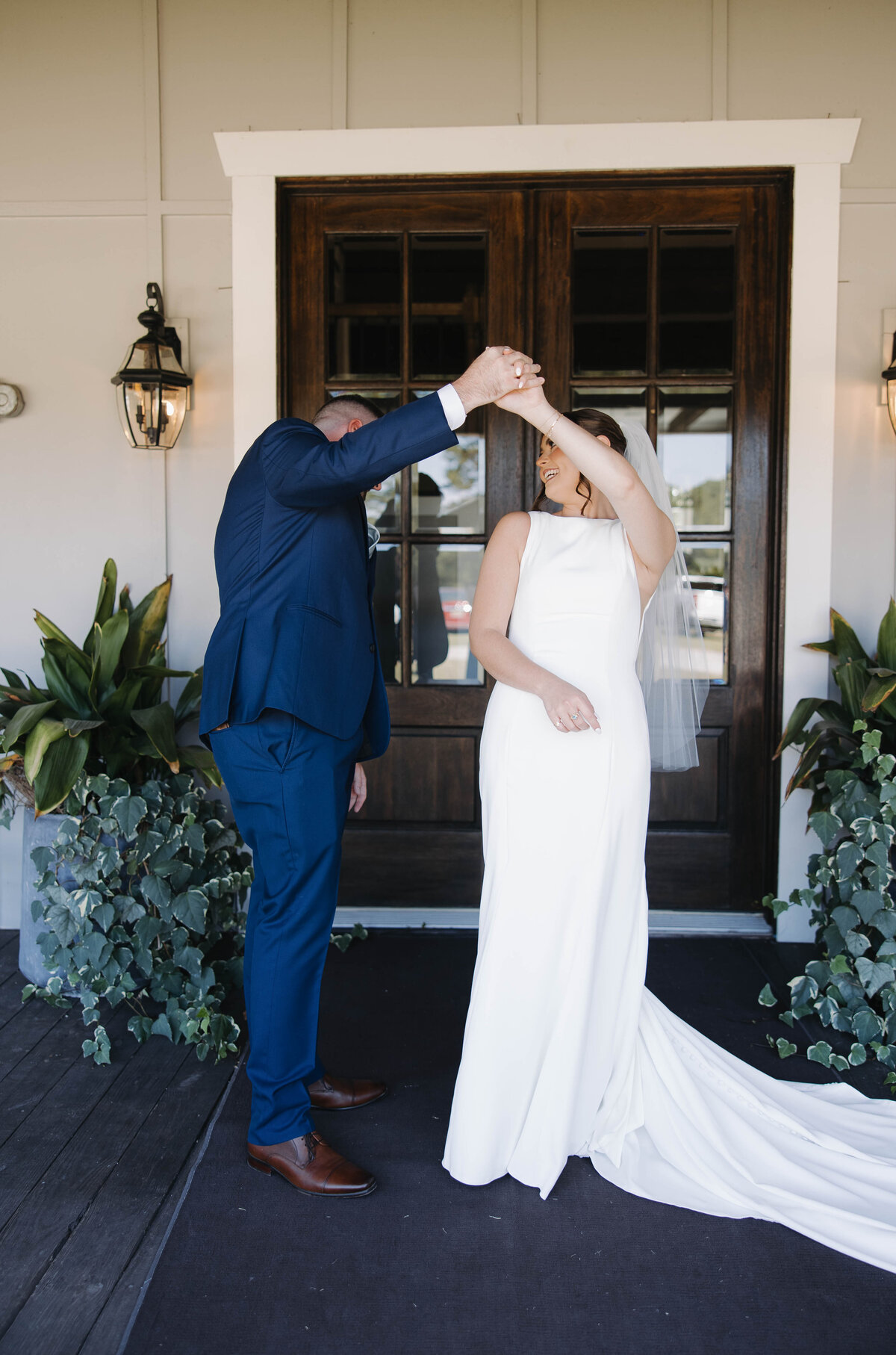 groom looking at his bride all dressed up