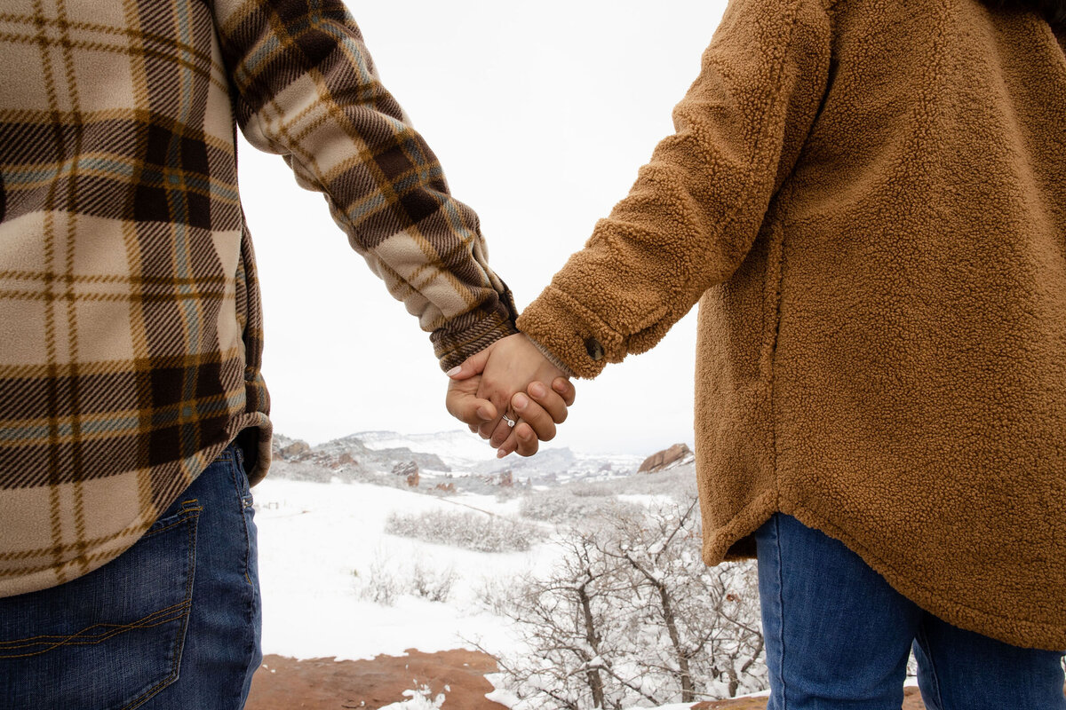 Couple holds hands in cold weather during Denver photoshoot