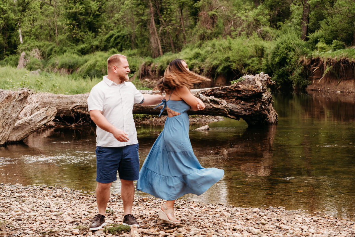 couple twirling on creek bed.  photo taken by Cape May photographer, Kristi