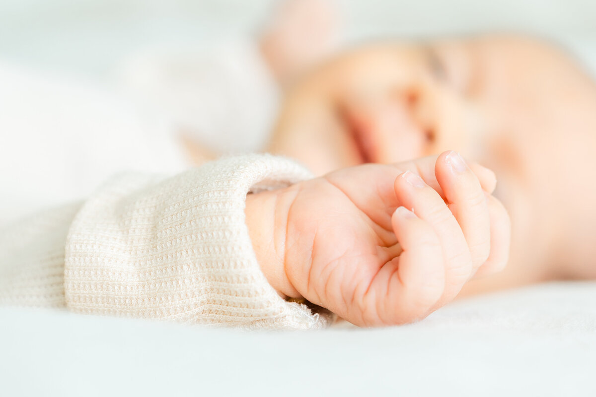macro shot of a newborn's hand with the focus on his finger nails