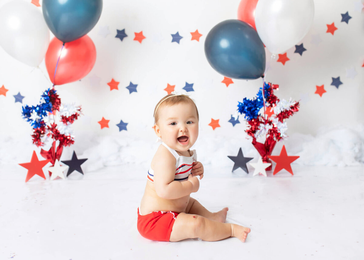 Baby girl laughing at her July 4th sitter session photoshoot in LA