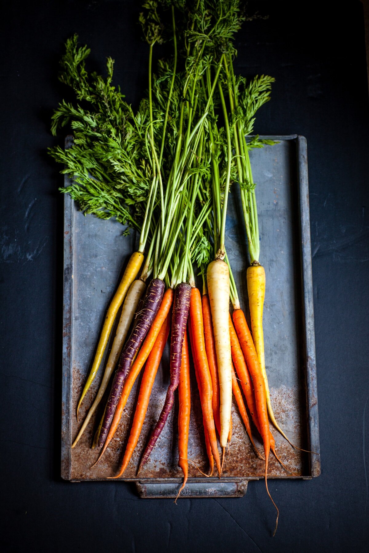 baking pan of colorful carrots to be roasted
