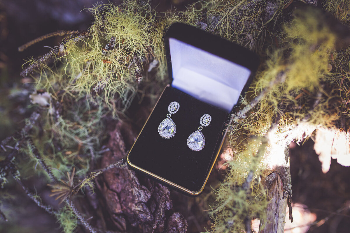 A close up of a bride's diamond wedding earrings.