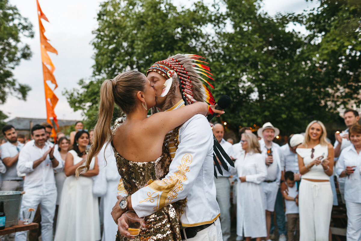 Couple kiss at their wedding warm up party