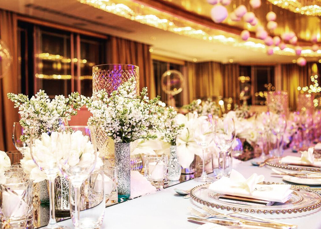 A luxurious wintery dinner design with white flowers and ice blue linen at The Dorcheste Hotel, London.