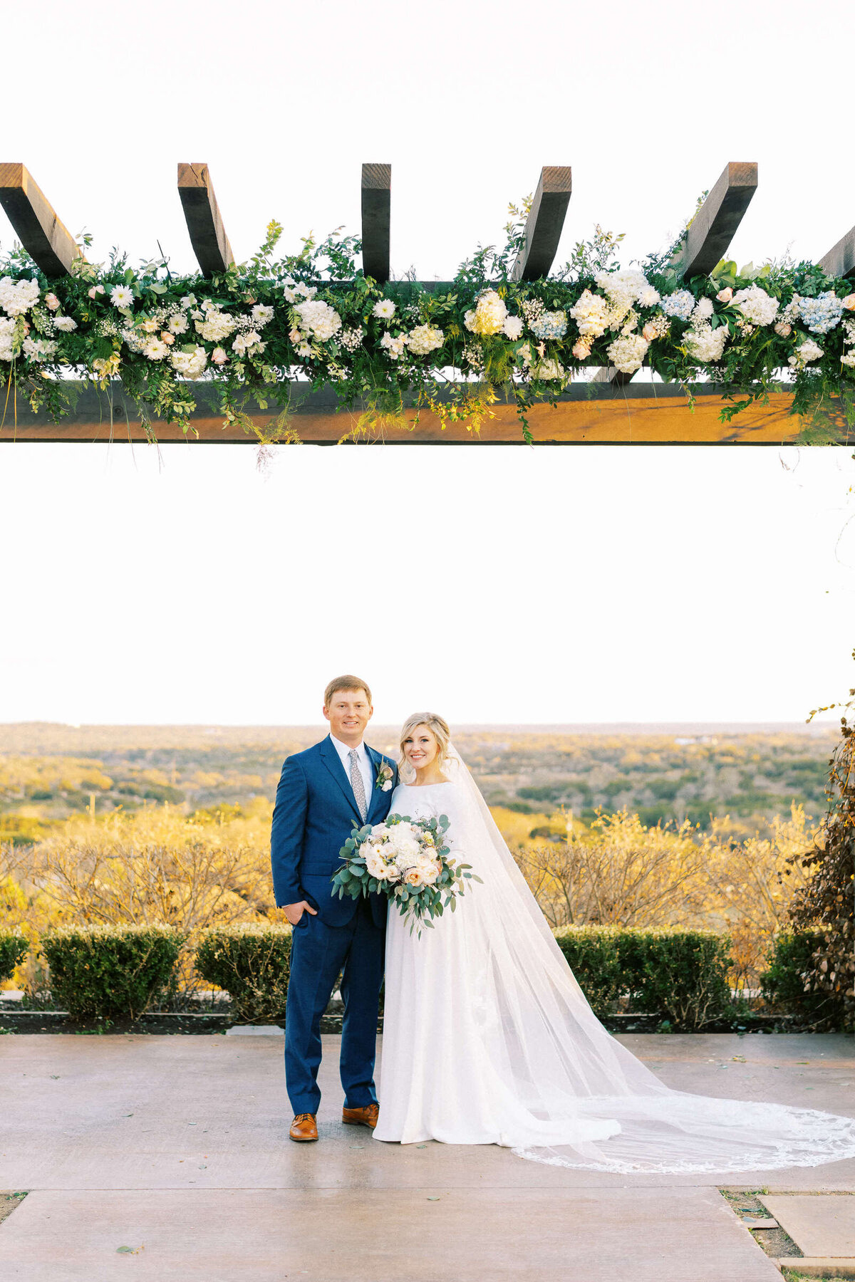 Central Texas couple poses at their wedding in Dripping Springs
