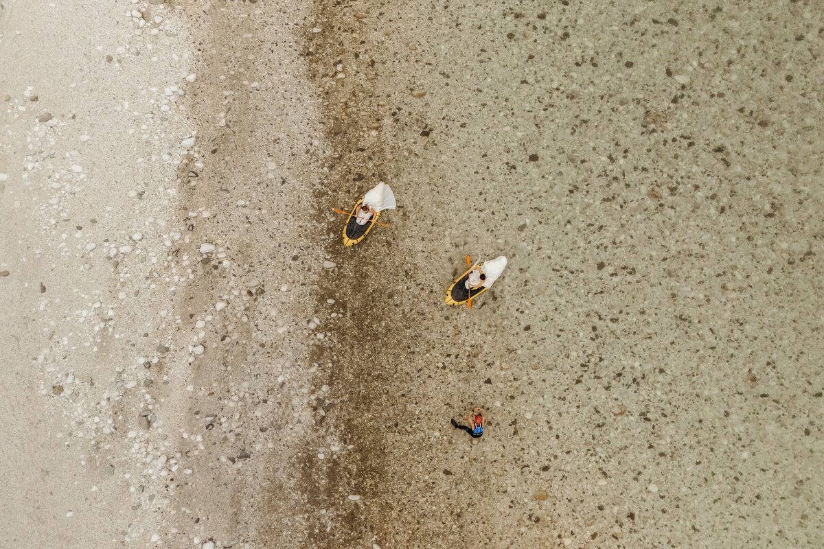 Aerial view of brides in yellow packraft in Soča Valley river elopement