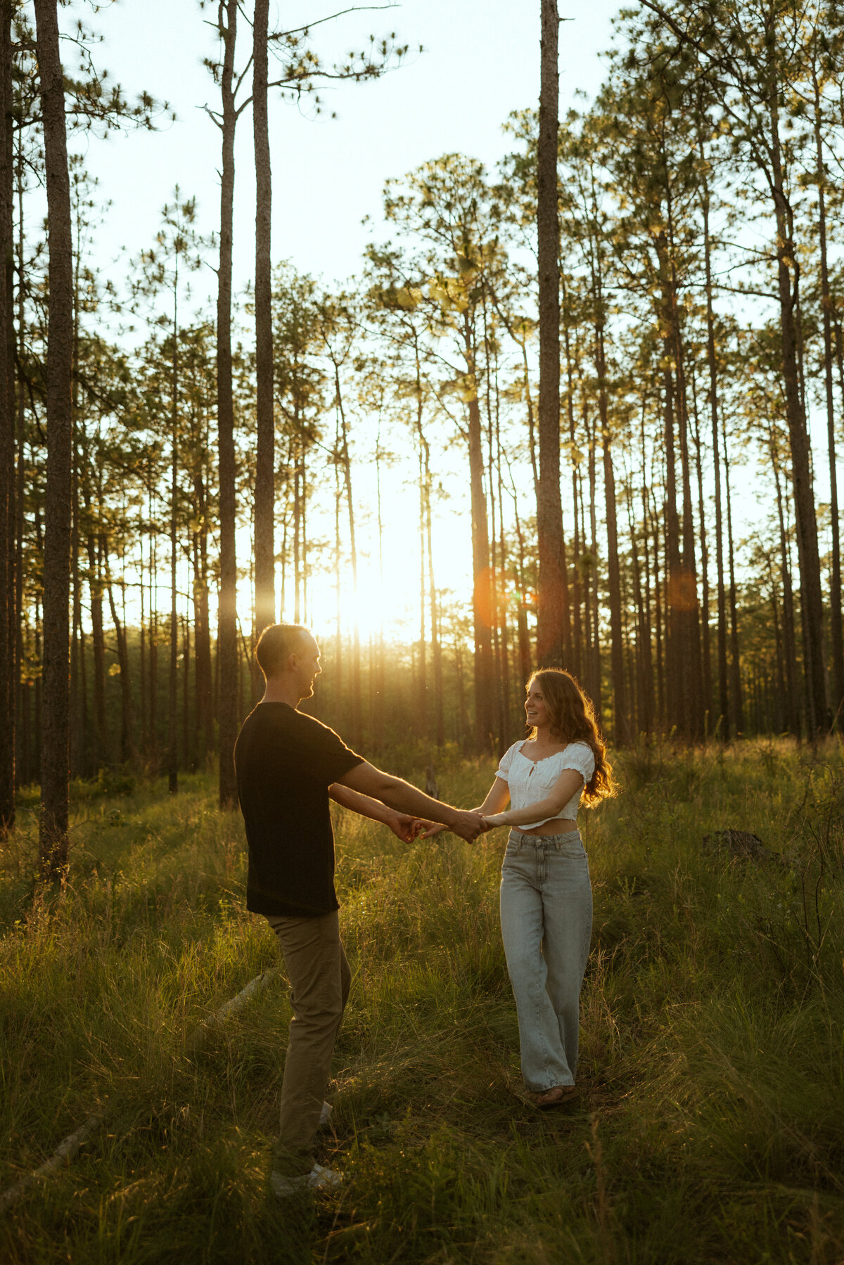 Couple posing for portraits in a forest.