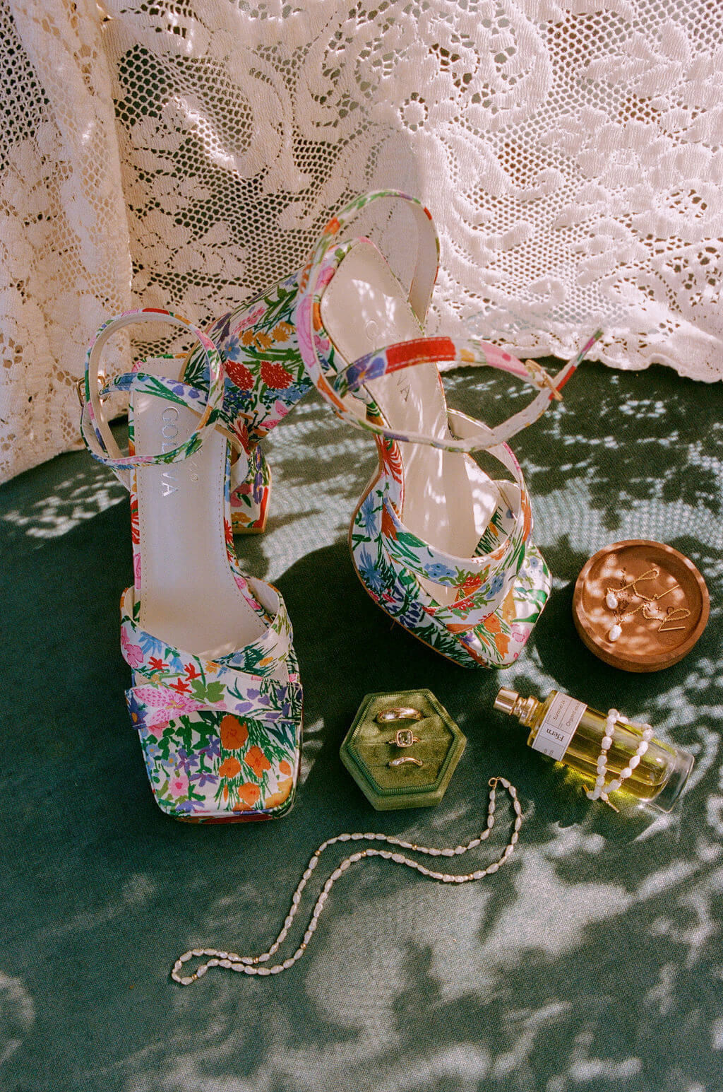 Garden wedding details including shoes, jewelry and perfume, representing the aesthetic of the wedding. 
