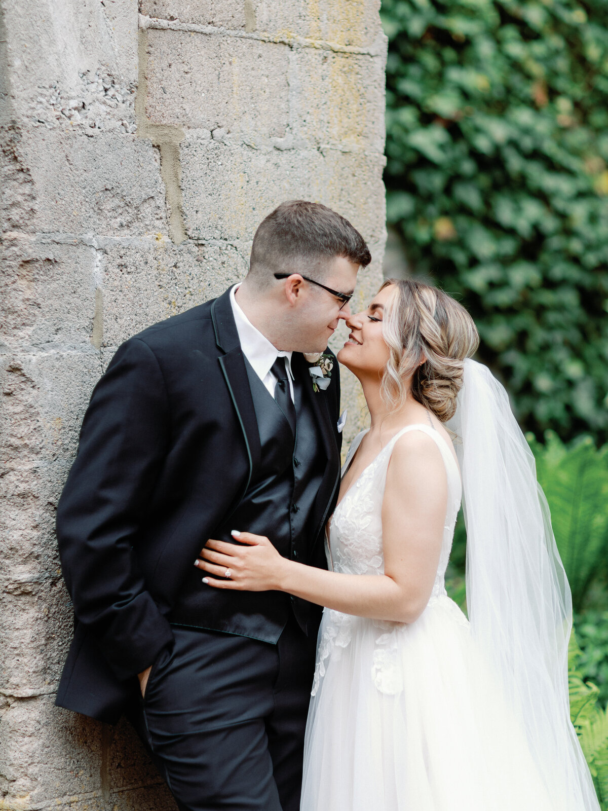 A bride and groom share the moment right before a kiss on their wedding day