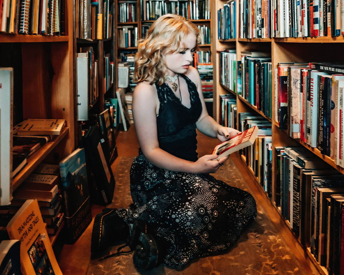 Senior girl on floor in bookstore