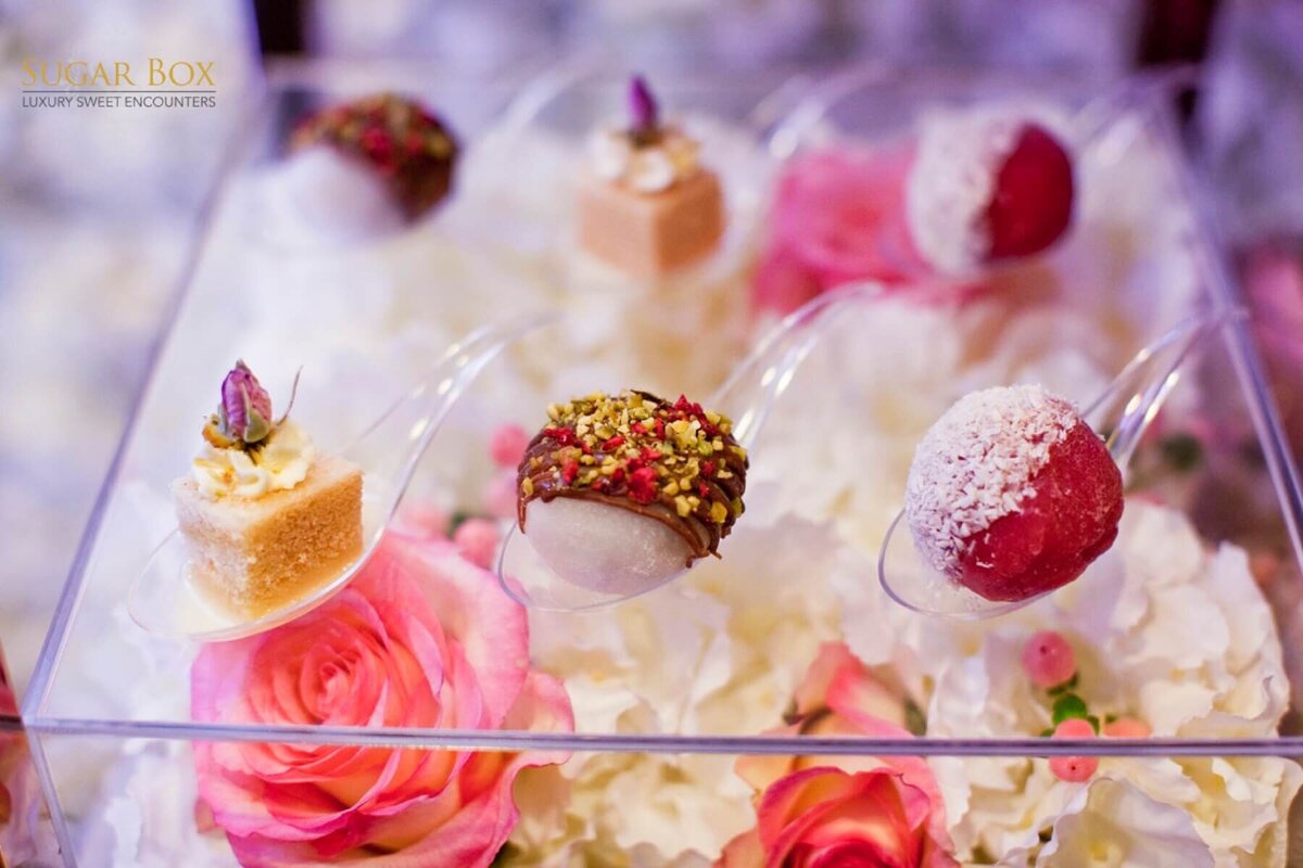 Beautiful mini dessert canapés on top of a floral box