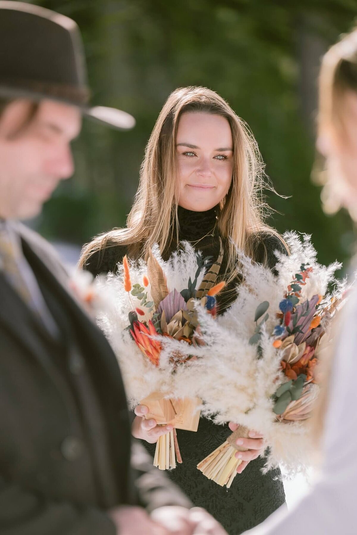 Bride's sister during tahoe winter elopement's ceremony looking at her sister. 