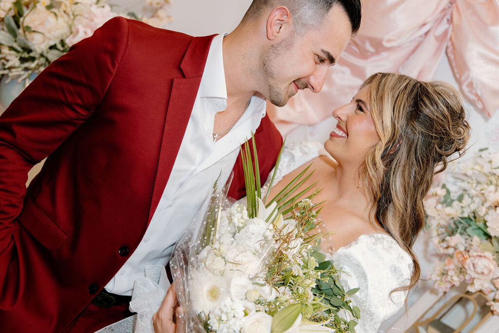 Bride and groom smiling at each other during their wedding day in New York City