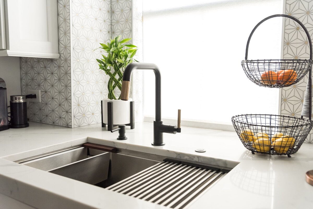 dewine design orlando interior designer modern lakehouse kitchen sink with black faucet and wire fruit basket