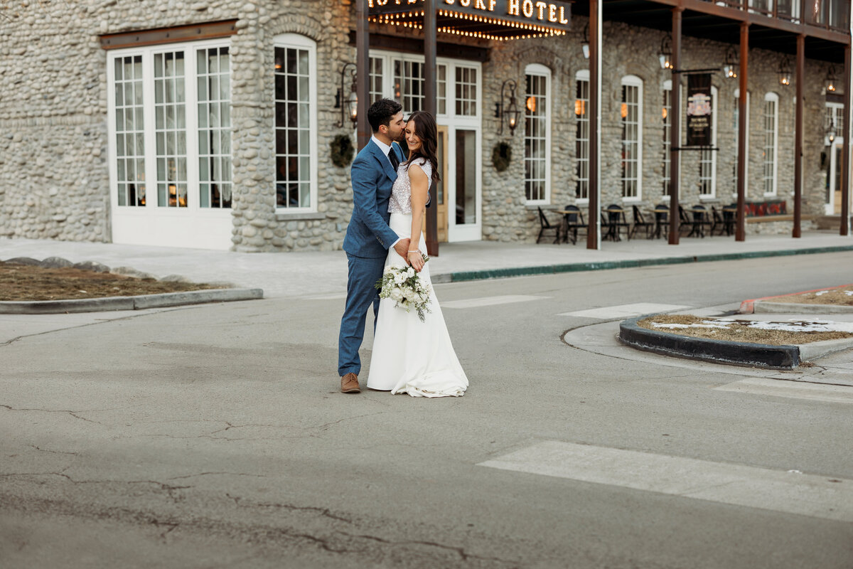 Newlyweds kiss in the street in front of Surf Hotel in Buena Vista, Colorado