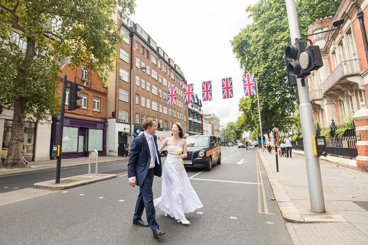 Bride and groom crossing street together