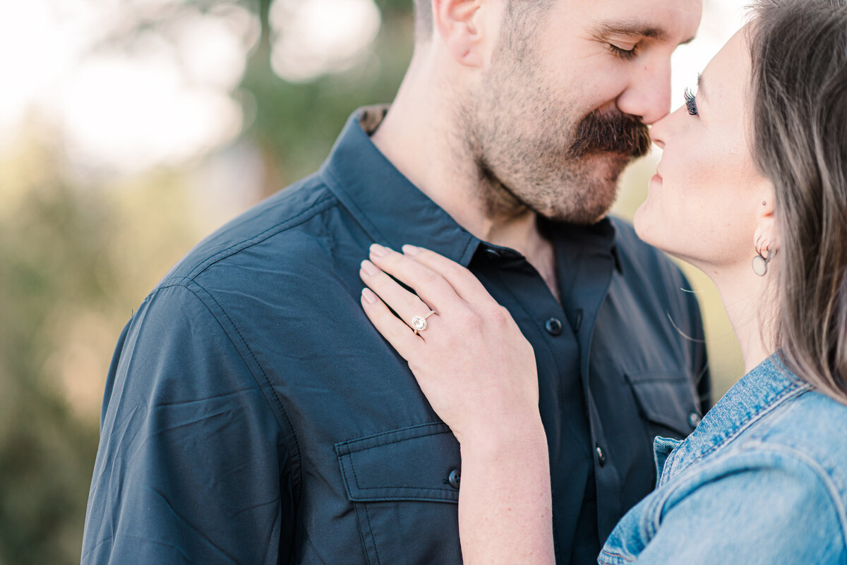 A close up shot of a couple about to kiss while the woman has her hand on the man's collar bone, captured by denver wedding photographer, kb radiant photography
