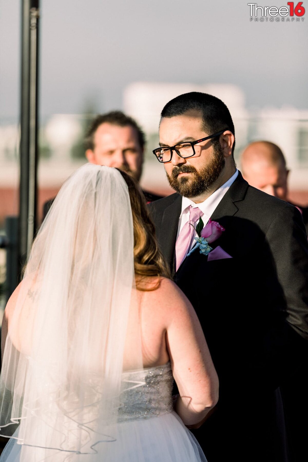 Groom gazes at his Bride as she reads him her vows