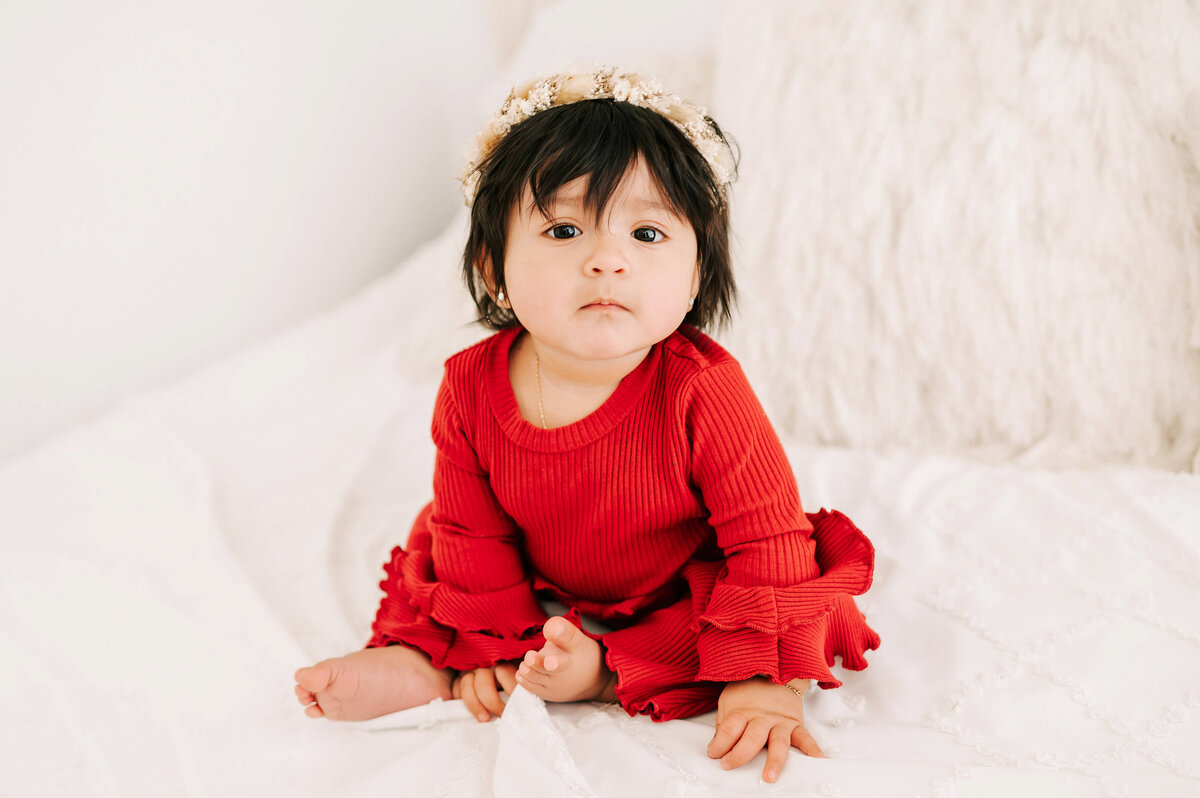 baby picture in Branson MO of little girl on bed in floral crown