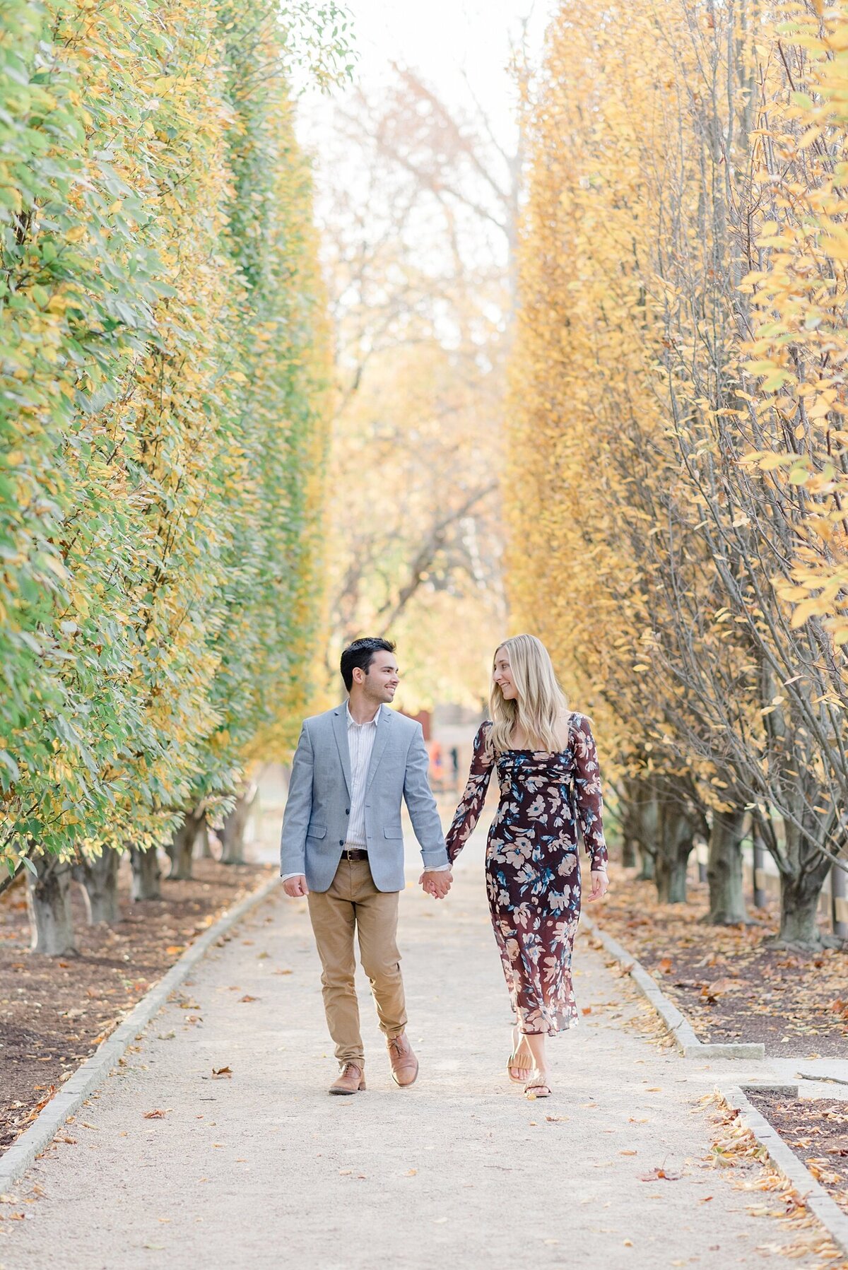 Couple walks on tree lined path photographed by Ohio Wedding Photographer