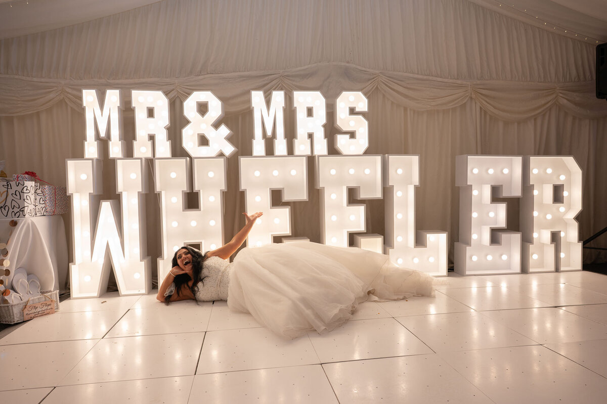 Bride laying down infront of MR & Mrs Sign - Wedding Photographer Manchester