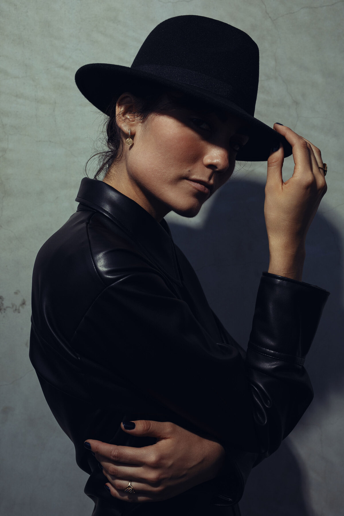 Portrait Photo Of Young Woman Touching Her Black Hat Los Angeles