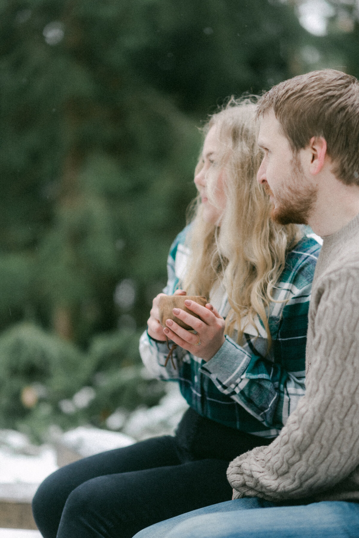 Kihlapari nuotiolla talvisessa kihlakuvauksessa valokuvaaja Hannika Gabrielssonin ottamassa valokuvassa