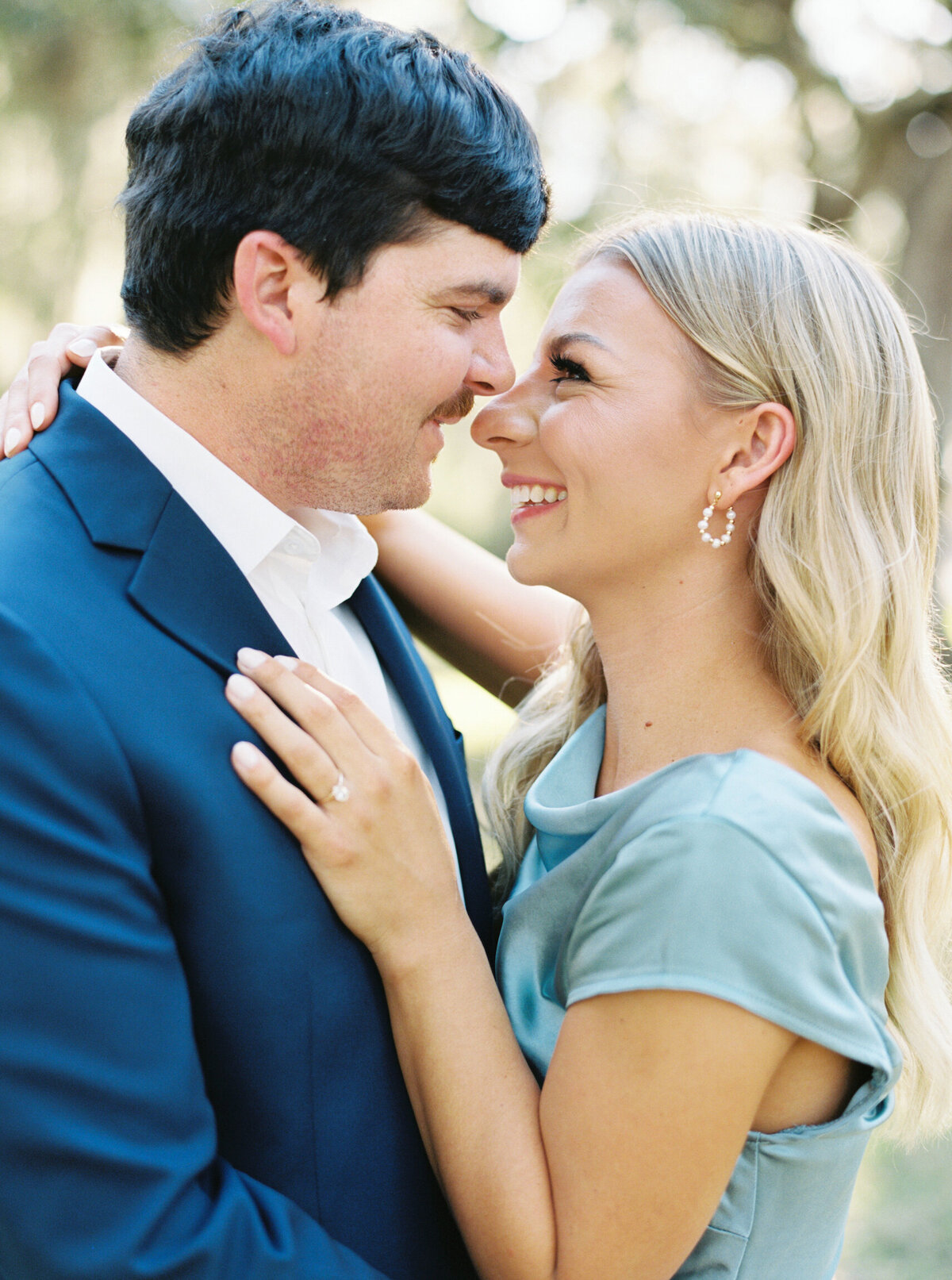 Couple embracing nose to nose during an intimate engagement session, captured on film by Morgan Alysse, fine art wedding photographer in Lafayette.